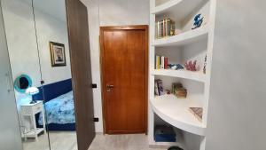 a small room with a wooden door and shelves at Sea and Blue Sky 3 in Calimera