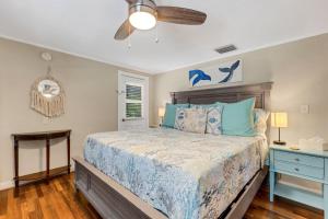 a bedroom with a bed and a ceiling fan at Water View & Heated Pool - Steps to Sand, Bayview Beauty B-5 in Clearwater Beach +19 photos
