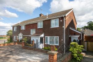 a brick house with a large driveway at Wickersley House, Rotherham for contractors & Families, free parkin, wifi etc in Wickersley