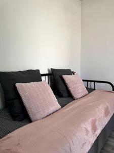 a bed with two pillows on top of it at Rose in Bellême