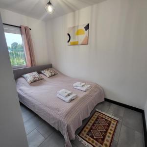 a bedroom with a bed with towels on it at Baltic Barns Berg in Wytowno