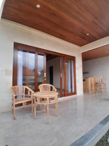 a patio with a table and two chairs at Ubud nadi villa in Tegalalang