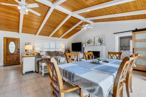 a dining room and living room with a table at Sandy Retreat Pool Home - Vacation Rental in Clearwater