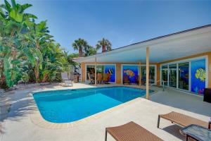 a swimming pool in the backyard of a house at Narcissus Beach House - Weekly Beach Rental in Clearwater Beach