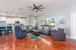 a living room with a couch and chairs and a table at Clearwater Beach Splendor - Weekly Beach Rental in Clearwater Beach
