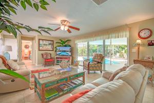 a living room with a couch and a table at Narcissus Beach House - Weekly Beach Rental in Clearwater Beach
