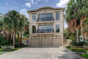 a large house with palm trees in front of it at Sweet Escape - Monthly Beach Rental in Clearwater Beach