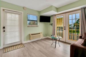 a living room with a couch and a table at Sunset Corner - Beach View & Heated Pool! in St Pete Beach