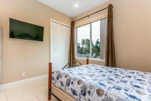 a bedroom with a bed and a large window at Sweet Escape - Monthly Beach Rental in Clearwater Beach