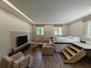 a large living room with a bed and a couch at Εμμέλεια in Karpenisi
