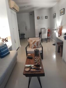 a living room with a couch and a coffee table at Arisara place in Koh Samui  +5 photos