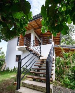 a house with stairs leading up to it at Modern Beachfront Apartment with Balcony in Puerto Viejo