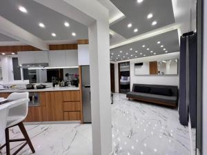 a kitchen and living room with a table and a couch at Seven Boutique Apartments Cancún in Cancún