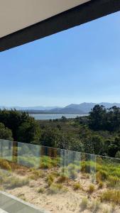 a view of the ocean from a house window at Villa Mavi - Praia do Rosa in Imbituba