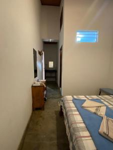 Cama ou camas em um quarto em Pousada Caminho do Vale Guiné