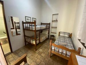 Cama ou camas em um quarto em Pousada Caminho do Vale Guiné