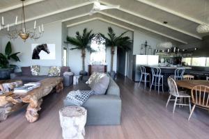 a living room with a couch and a table at Culburra Beach House in Culburra Beach