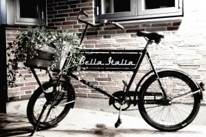 a bicycle parked in front of a brick building at Hotel Bella Italia in Sønderborg