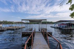 Sunrise BeachFunky Little Lakehouse - private dock and sunset view的船在水体上的码头