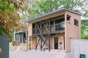 a large house with a balcony on top of it at DAHARA n-2 in Minami Aso