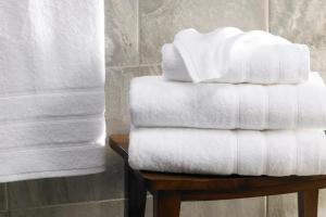 a stack of towels on a table in a bathroom at Cool Covent Garden Theatre Design Hub for Families Friends Couples in London +22 photos