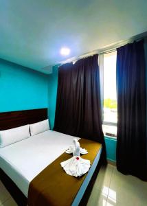 Postel nebo postele na pokoji v ubytování ARK Serendah Hotel