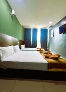 Postel nebo postele na pokoji v ubytování ARK Serendah Hotel