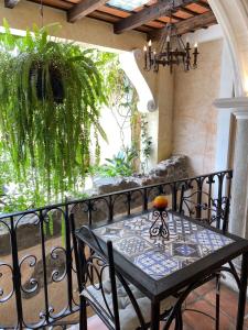 a black table and chairs on a balcony at Hotel Casa Victoria in Antigua Guatemala