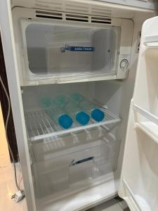 an open refrigerator with blue food inside of it at LUXE 2 BR Apartment Spacious And Modern Lounge in Karachi
