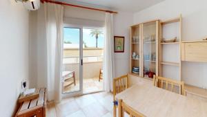 a dining room with a table and a window at Holidoo Travel "Casa Mya" in Los Alcázares
