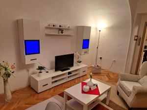 a living room with a flat screen tv on a wall at LuMiDo in Osijek