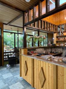 a large kitchen with wooden walls and a large counter at Juta Guest House in Jut'a