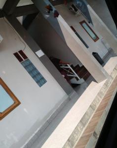 an aerial view of a living room with a person sitting on a chair at Kost Griya Apung in Jepara