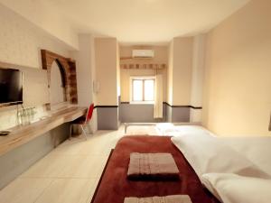 Postelja oz. postelje v sobi nastanitve Hotel Syariah Larismanis