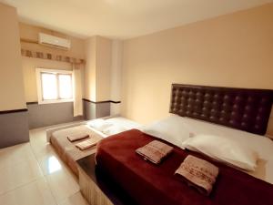 Postelja oz. postelje v sobi nastanitve Hotel Syariah Larismanis