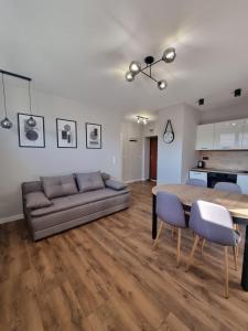 un salon avec un canapé et une table dans l'établissement Przytulne mieszkanie z balkonem dostęp na kod, à Radom