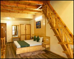 a bedroom with a bed in a room with a staircase at The Gruhum in Manāli