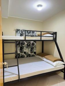 a couple of bunk beds in a room at The Catolico's Transient House in Baguio