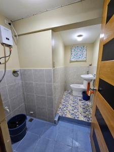 a bathroom with a toilet and a sink at The Catolico's Transient House in Baguio +21 photos