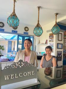 two women standing behind a counter with a welcome cake at Sunset Beach Villas in Haad Rin +86 photos
