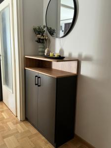 a bathroom with a vanity and a mirror at Fairy tale apartment 8 in Voždovac