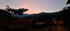 a view of the mountains with a sunset in the background at BUKIT LIMAU REST HOUSE in Taiping