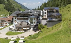 an aerial view of a house on a hill at Hotel Alpenhof Superior in Zauchensee