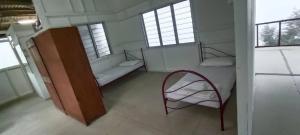 Voodi või voodid majutusasutuse Bukit Limau rest house Merbau toas