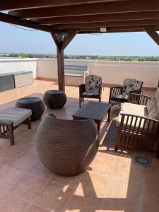 a patio with chairs and furniture on a roof at Appartement Dolores in Dolores