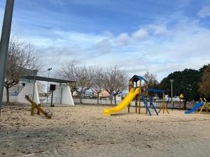 a playground with a slide in the sand at Appartement Dolores in Dolores