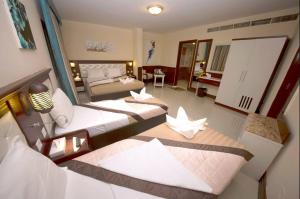 Postel nebo postele na pokoji v ubytování Mariana Hotel
