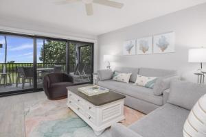 a living room with a couch and a table at Pelicans Roost 101 condo in Sanibel