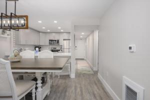 a kitchen and dining room with a table and chairs at Pelicans Roost 101 condo in Sanibel