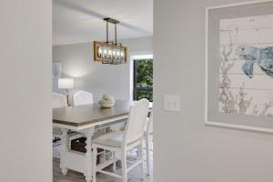a dining room with a white table and chairs at Pelicans Roost 101 condo in Sanibel